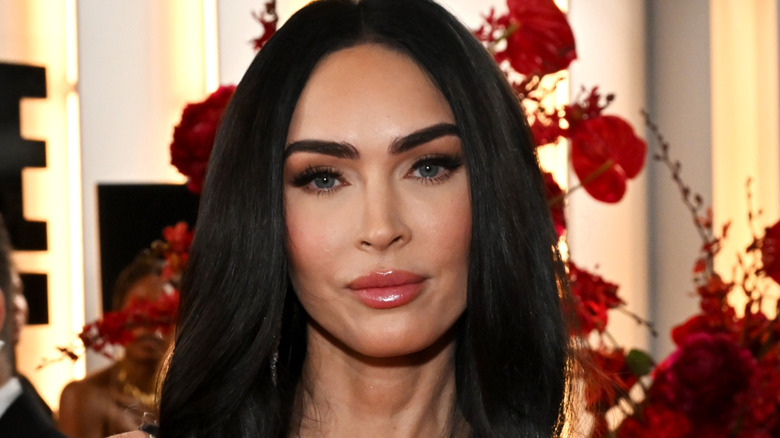 Megan Fox at an event in a white dress