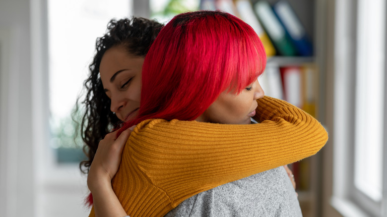 Two women hugging 