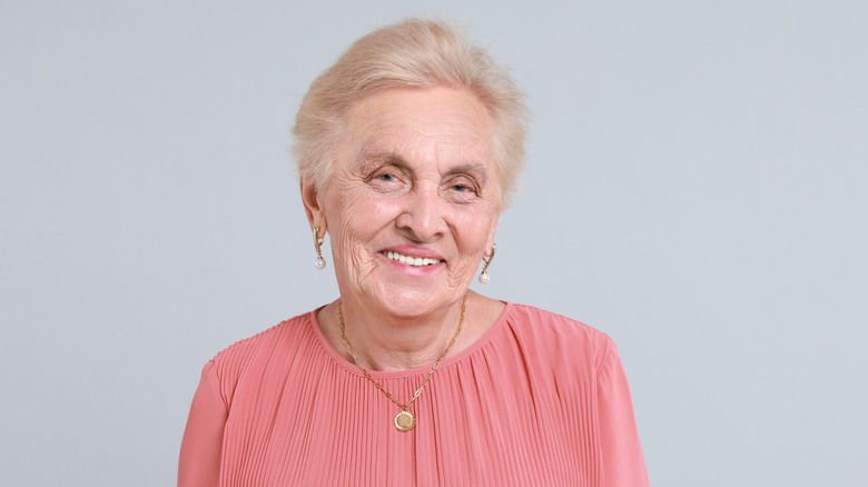 Woman wearing peach-toned blouse