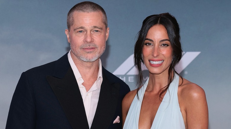 Brad Pitt and Ines de Ramon posing on the red carpet