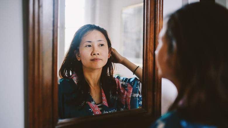 Woman looking into mirror 