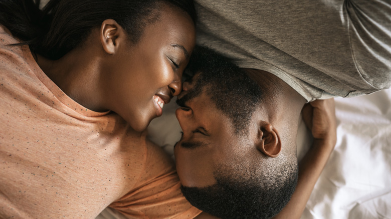 Couple embracing in bed