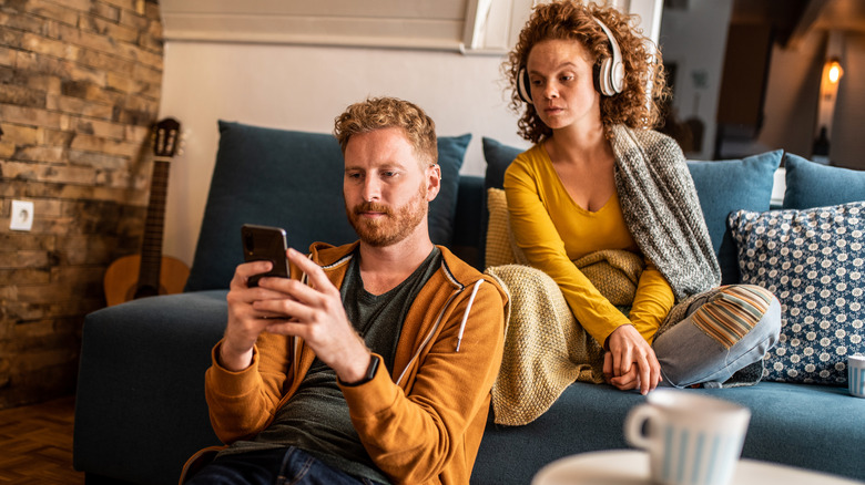 woman looking at man's phone