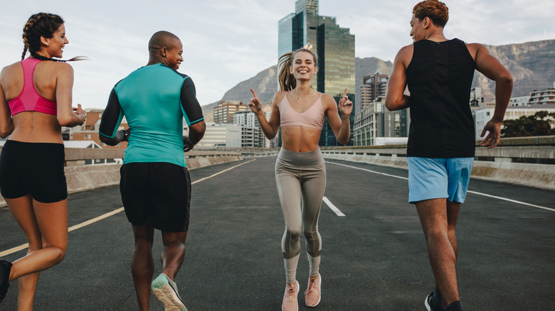 woman running backwards with forward runners