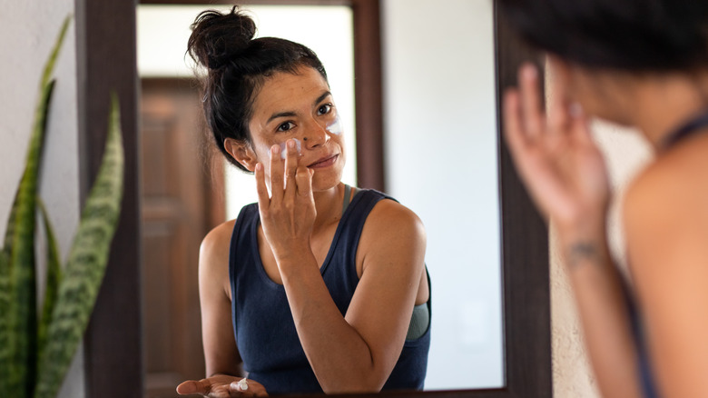Woman applying skincare