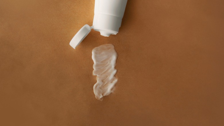 A tube of toothpaste on skin