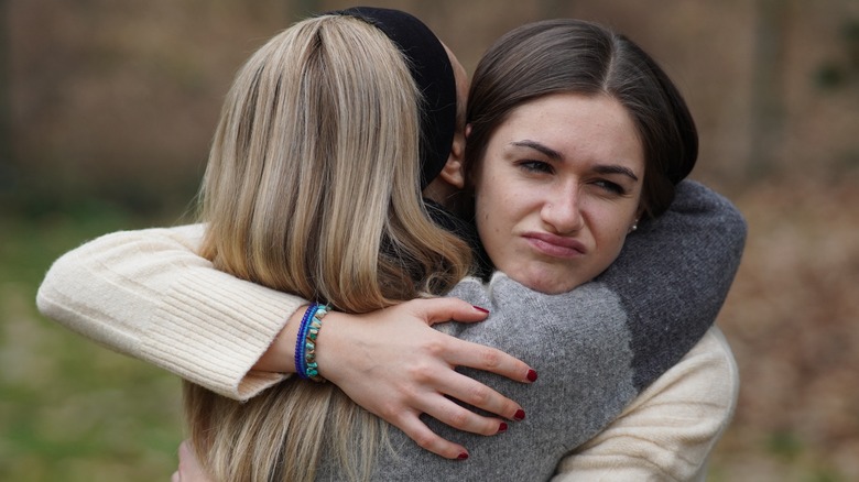 people fake hugging
