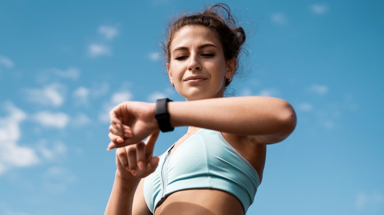 Woman checking fitness watch