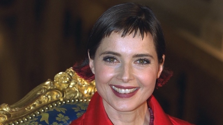 Isabella Rossellini smiling in 1996 while wearing a red jacket