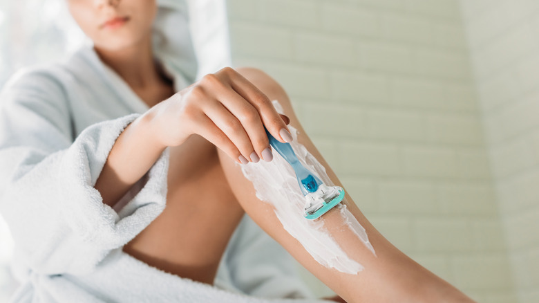 woman shaving legs 