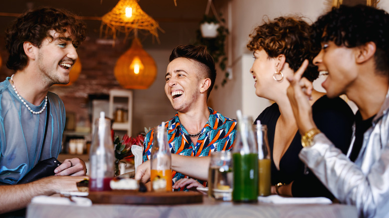 Queer friend group at restaurant