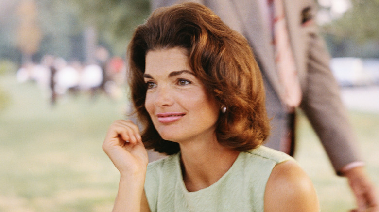 Jackie Kennedy in a green sleeveless dress