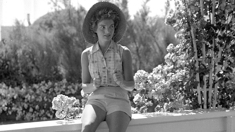 Jackie Kennedy in a sun hat and shorts at Hyannis Port