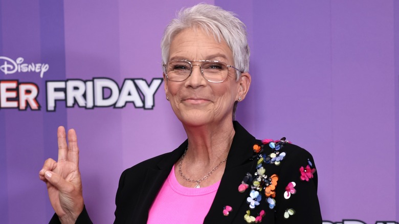 Jamie Lee Curtis giving the peace sign on the red carpet
