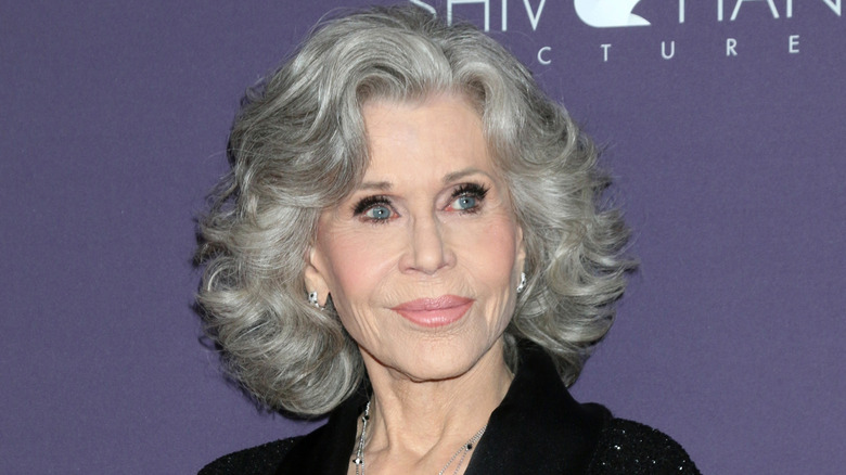 Jane Fonda with gray hair and a black blazer at an event