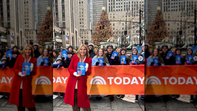 Jenna Bush Hager standing in front of a crowd holding a copy of "Homeschooled"