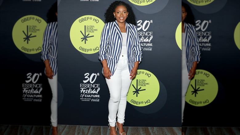 Jasmine Crockett in a striped blazer and skinny jeans