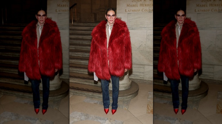Jenna Lyons poses wearing jeans and a red fur coat