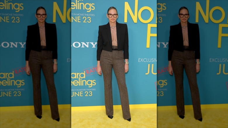 Jenna Lyons poses wearing a netted top and a cropped black blazer