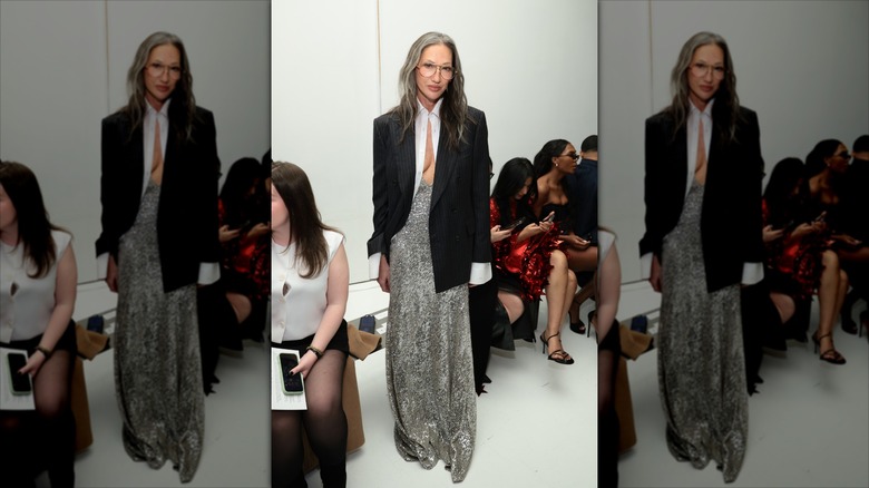 Jenna Lyons poses wearing a white shirt and a black blazer and a silver sequin maxi skirt
