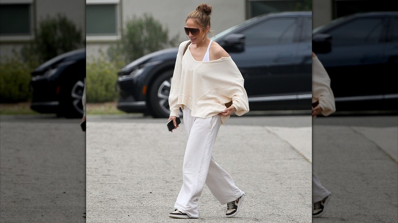 Jennifer Lopez in a white and cream sweats outfit in 2024