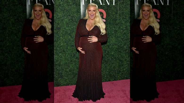 Jessica Simpson holding her baby bump on the red carpet in 2018