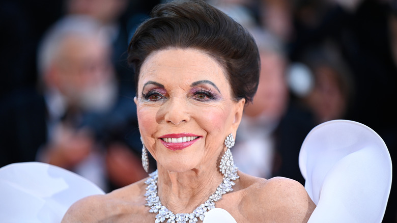 Dame Joan Collins smiles on the red carpet in 2026