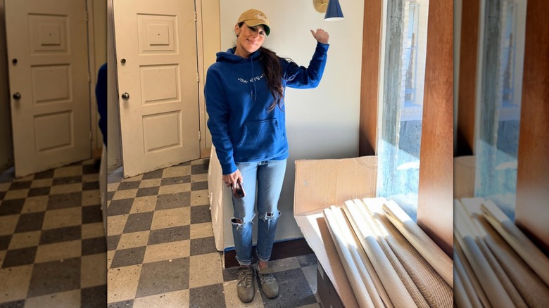 Joanna Gaines wearing a blue sweatshirt and baseball cap