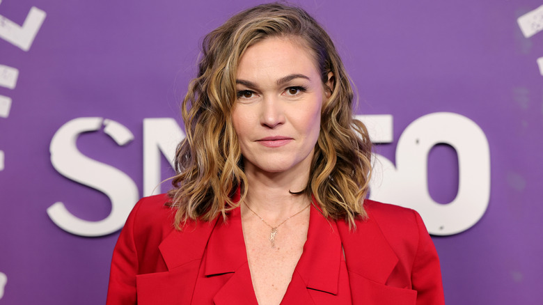 Julia Stiles wearing a red blazer