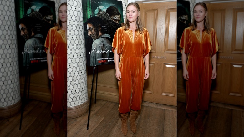 Julia Stiles wearing an orange velvet jumpsuit