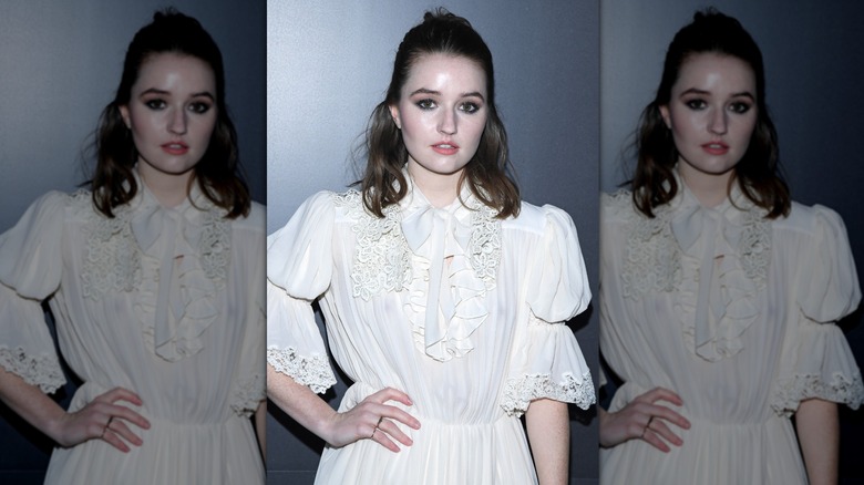 Kaitlyn Dever posing with a half-up hairstyle at the Paris Fashion Week in 2020