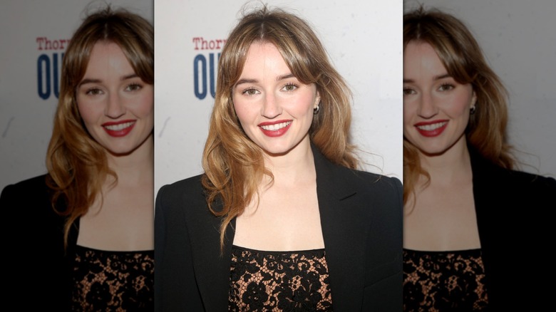 Kaitlyn Dever smiling while wearing curtain bangs at a Broadway premiere