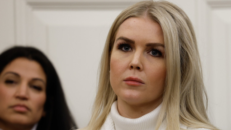 Karoline Leavitt in a white turtleneck looking serious