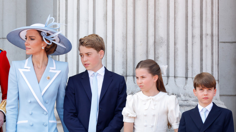 The Princess of Wales wearing a blue and white coat dress alongside her three children