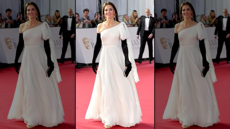 Kate Middleton on the red carpet in a white one-shoulder gown with black elbow-length gloves
