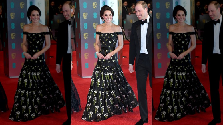 Kate Middleton on the red carpet, next to Prince William, in a black floral gown