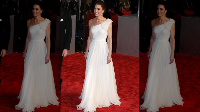 Kate Middleton on the red carpet in a white one-shouldered chiffon dress