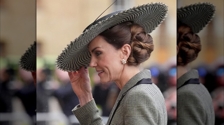 Kate Middleton wearing a large brimmed hat and large pearl earrings
