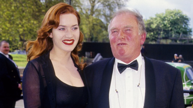 Kate Winslet smiling while at an event with her dad in 1997
