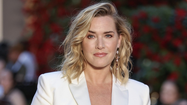 Kate Winslet with a neutral expression and a wavy bob in front of a slightly blurred background