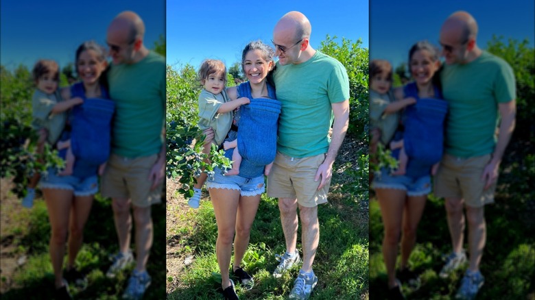 Katie Miller and her family posing for a photo after picking blueberries