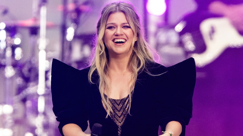 Kelly Clarkson smiling on stage