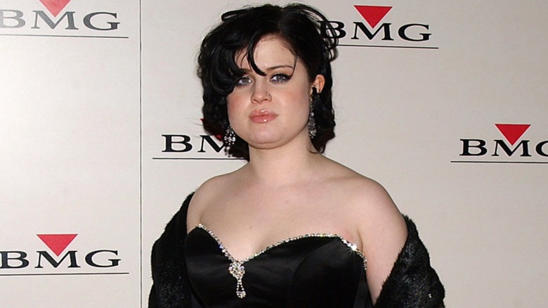Kelly Osbourne on the red carpet in 2004 wearing a strapless black gown