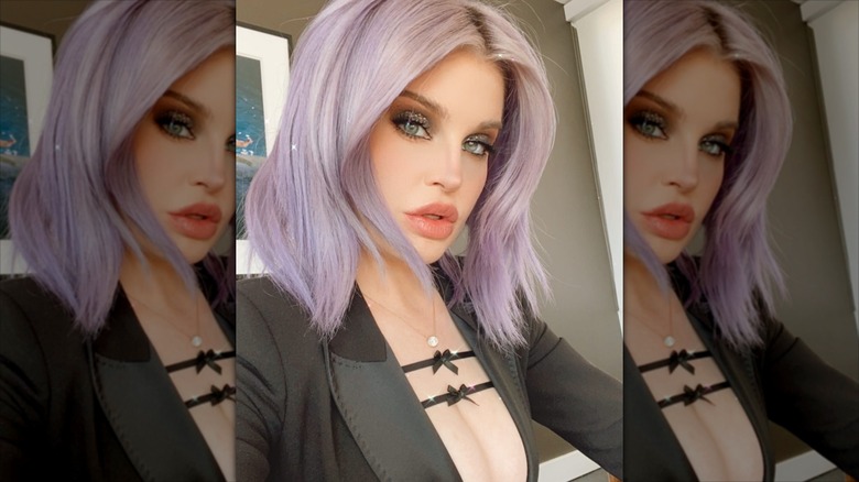 Kelly Osbourne posing for a selfie in 2021, with lavender hair