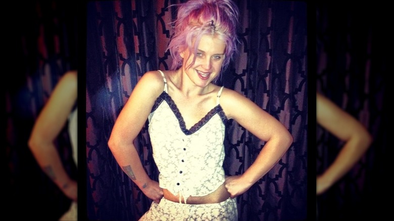 Kelly Osbourne posing with her hands on her hips while wearing pajamas