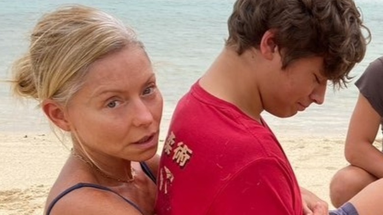 Kelly Ripa at the beach, posing without makeup alongside her children