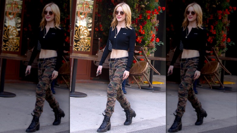 Kiernan Shipka spotted in New York City wearing a cropped long-sleeved shirt and camo pants