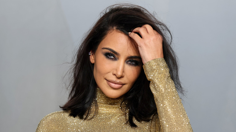 Kim Kardashian wearing a gold dress at 2026 Oscars party