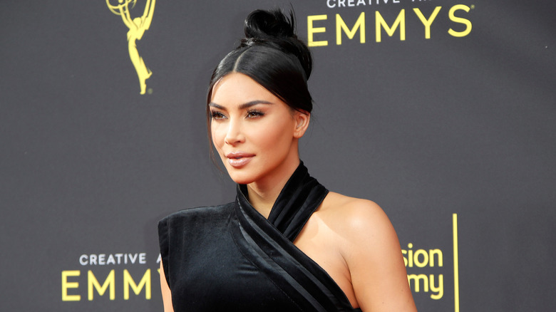 Kim Kardashian on the red carpet in a black dress