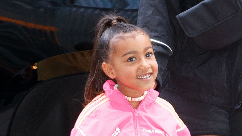 North West wearing a pink two-piece Adidas tracksuit